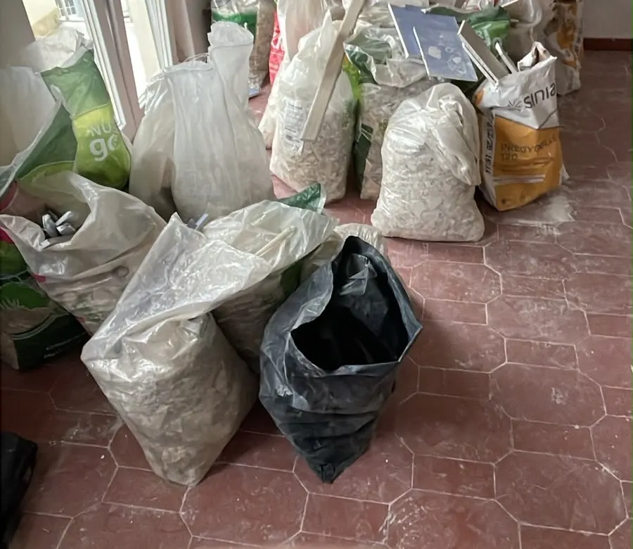 Sacos de entulho cheios no chão de uma casa em obras